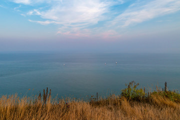 Sailing boats at sea off the Sussex coast, at Beachy Head
