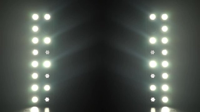 Realistic footage of stage light flashing rays spotlights through smoke