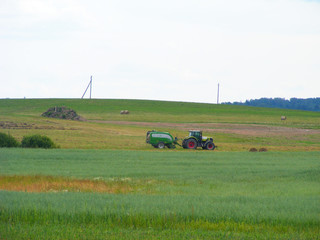 Tractor on farm landscape, agriculture farming concept.