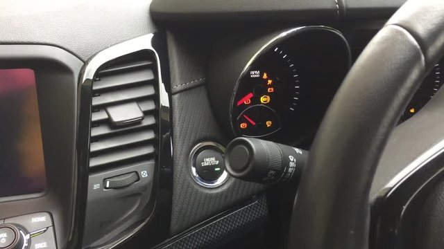 Pushing engine start button on high end car