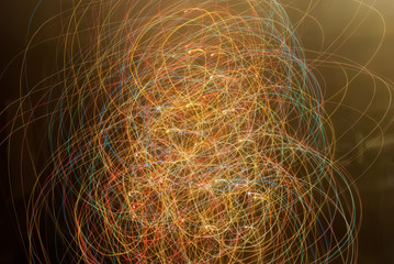 Blurred colorful lights in motion. Abstract background in brown tones and multicolor lines