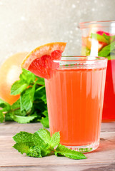 Grapefruit cocktail with ice and mint, selective focus