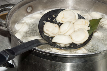 Dumplings stew in the pot with spices and the Bay leaf.