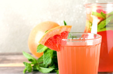 Grapefruit cocktail with ice and mint, selective focus