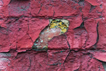 A fragment of an old brick wall painted many times. Peeling paint. Texture. Background