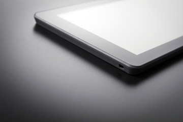 Black Tablet With Reflection Lying On A Dark Background