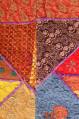 Background of colorful patchwork fabrics. Ethnic textile