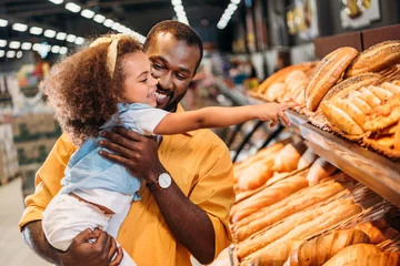 Gordijnen african american little child pointing by finger at pastry to father in supermarket © LIGHTFIELD STUDIOS