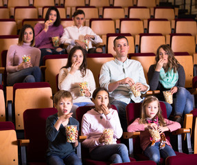 Numerous audience attending movie night with popcorn