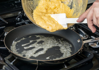 Cooking Paleo Coconut Flour Pancakes in a frying pan - 215156005