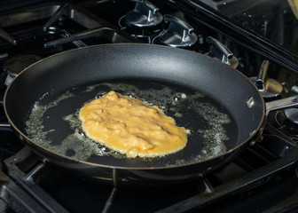 Cooking Paleo Coconut Flour Pancakes in a frying pan