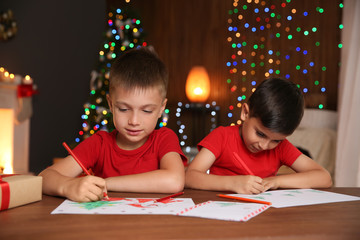 Little children drawing pictures at home. Christmas celebration