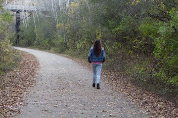 girl walking alone on road