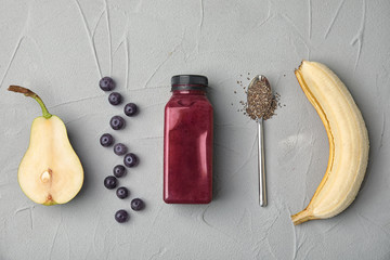 Flat lay composition with ingredients for delicious acai cocktail and bottle of juice on gray table © New Africa