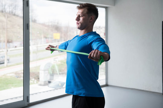 Man Warms Up With The Latex Resistance Band