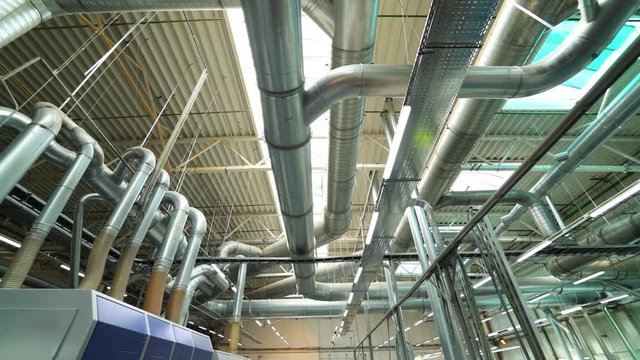 Industrial factory ceiling with ventilation system and lights. Ventilation ducts.