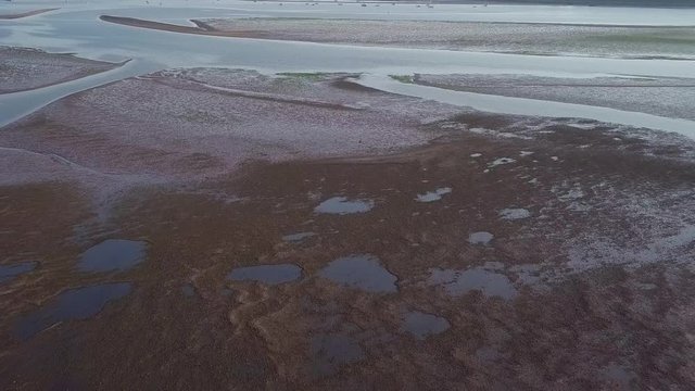 Aerial view of coastal town of Lympstone off of the English channel southwest of England. The beach is visible in the distance, as well as land and homes.