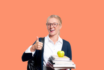 Happy young student girl holding books.  Back to school