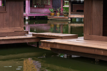 Peaceful thai floating architecture with traditional wooden house and bridge in Ancient City, Thailand, Asia