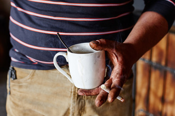 Working at the factory during the lunch break with a Cup and a c