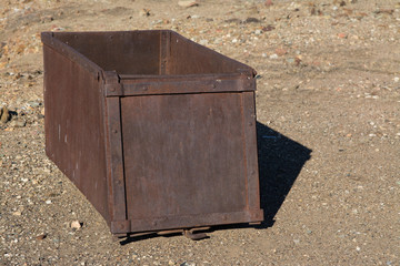 Old metal rusty box on ground