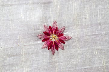 Embroidered satin seam, melange threads,red pink flower cornflower on coarse cotton fabric
