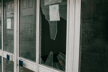 A broken window in a residential building or store as a result of an earthquake or vandalism or...