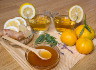 Still life. Tea in transparent cups. Honey, ginger, lemon and tangerines. From cold and flu.