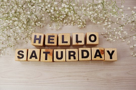 hello saturday alphabet letters on wooden background