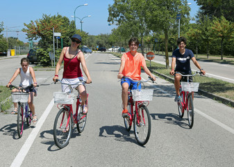 Fototapeta premium family of four people on the bikes