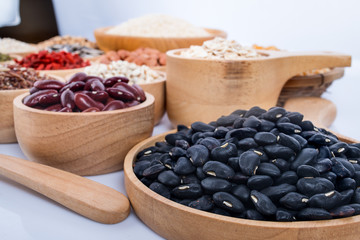 Cereal grains , seeds, beans on wooden background