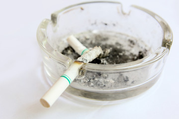 burned cigarettes in tray , no smoking concept