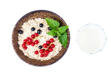 Oat flakes with berries, milk in glass