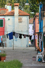 Fototapeta premium clothes hung out to dry between two houses in Burano