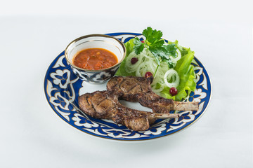 meat in a beautiful plate with lettuce and onion
