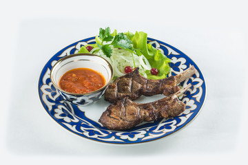 meat in a beautiful plate with lettuce and onion
