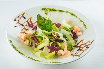 close-up vegetable salad with fish in white plate
