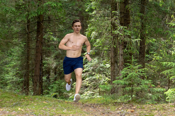 The athlete commits a morning run through the forest