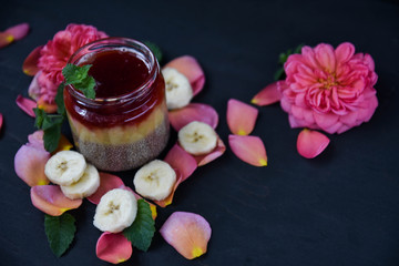 Fototapeta na wymiar desert chia pudding. tea rose with banana. art soft focus