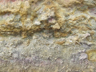 Fragment of the wall with a coarse yellow stone