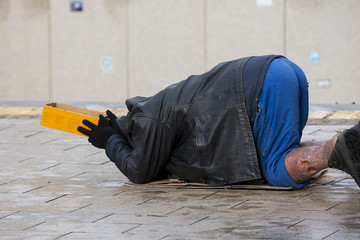 Homeless man begs for money