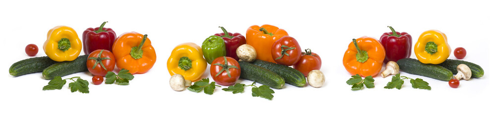 Panoramic view of the red yellow and orange peppers with tomatoes on a white background..Cucumbers with colorful peppers in composition on a white background.