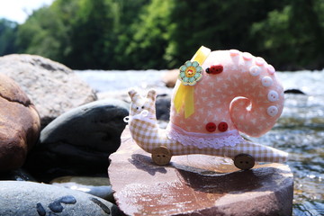 The image of the toy is a snail. Handmade.