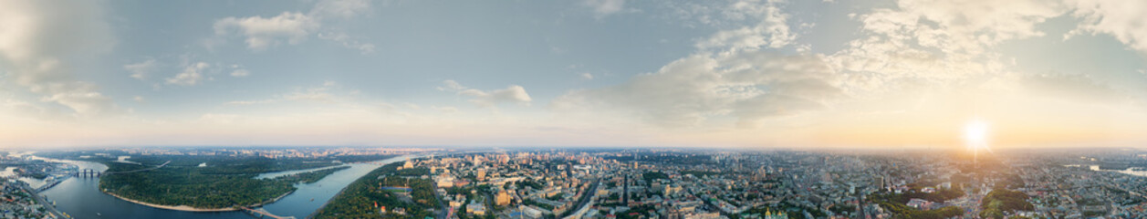 A big 360 degrees panorama of the city of Kiev at sunset. A modern metropolis in the center of Europe against the backdrop of sunset sky from a bird's eye view. Aerial view. Panorama of the Tourist