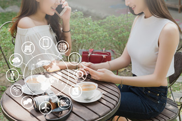 Two teenage women use smartphone with technology icon, internet of things conceptual
