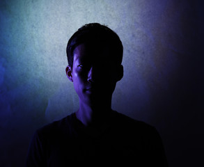 Silhouette of a man deep in thought. A side view of a person who is seriously concerned.