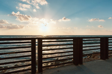  fence against the sea at sunset