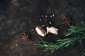 Rosemary, star anise on rustic background