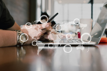 Hand of man use smartphone and laptop with technology of globalization connectivity conceptual