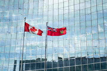 Canada Flag and Ontario Flag in Front of Glass Building - 215197201